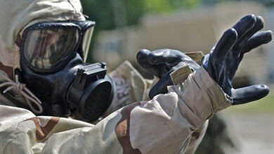 Soldier wearing protective gear assisting in the decontamination process after a dirty bomb explosion