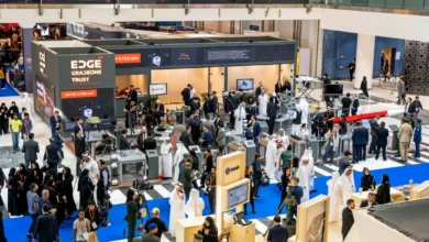 Visitors gather around the EDGE Group exhibition booth at a defense technology event showcasing drones and UAV systems