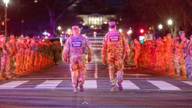 U.S. Army Command Sgt. Maj. Scott McKennon, senior enlisted leader of Joint Task Force–District of Columbia, left, and Col. Larry Doane, the task force’s commander, right, walk down a Soldier-lined street as they prepare to honor U.S. Army Spc. Sarah Beckstrom of the West Virginia National Guard in Washington, D.C., Nov. 27, 2025. A fallen soldier procession was held to pay tribute to Beckstrom’s life and service. (U.S. Army National Guard photo by Sgt. Clay Smith)