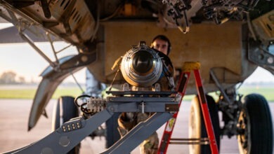 A GBU-38 Joint Direct Attack Munition is prepared to be secured in the bomb bay of a B-52H Stratofortress