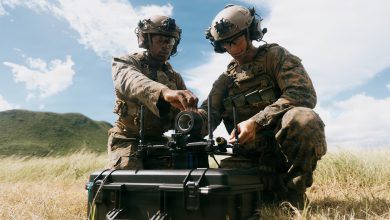 U.S. Marine Corps riflemen with Light Armored Reconnaissance Company, Battalion Landing Team 3/6, 22nd Marine Expeditionary Unit (Special Operations Capable), load a simulated warhead onto a Neros Archer first-person view drone during attack drone training on Camp Santiago, Puerto Rico, Nov. 19, 2025. 22nd MEU(SOC) Marines are being trained and certified by the 2nd Marine Division and the Marine Corps Attack Drone Team on first-person view drone systems to enhance combat readiness. U.S. military forces are deployed to the Caribbean in support of the U.S. Southern Command mission, Department of War-directed operations, and the president's priorities to disrupt illicit drug trafficking and protect the homeland. (U.S. Marine Corps photo)