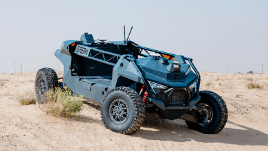 An xRift drives through a vast desert landscape under a clear blue sky.
