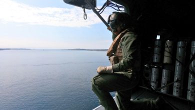 UK Royal Navy crewmember drops sonobouys into the sea