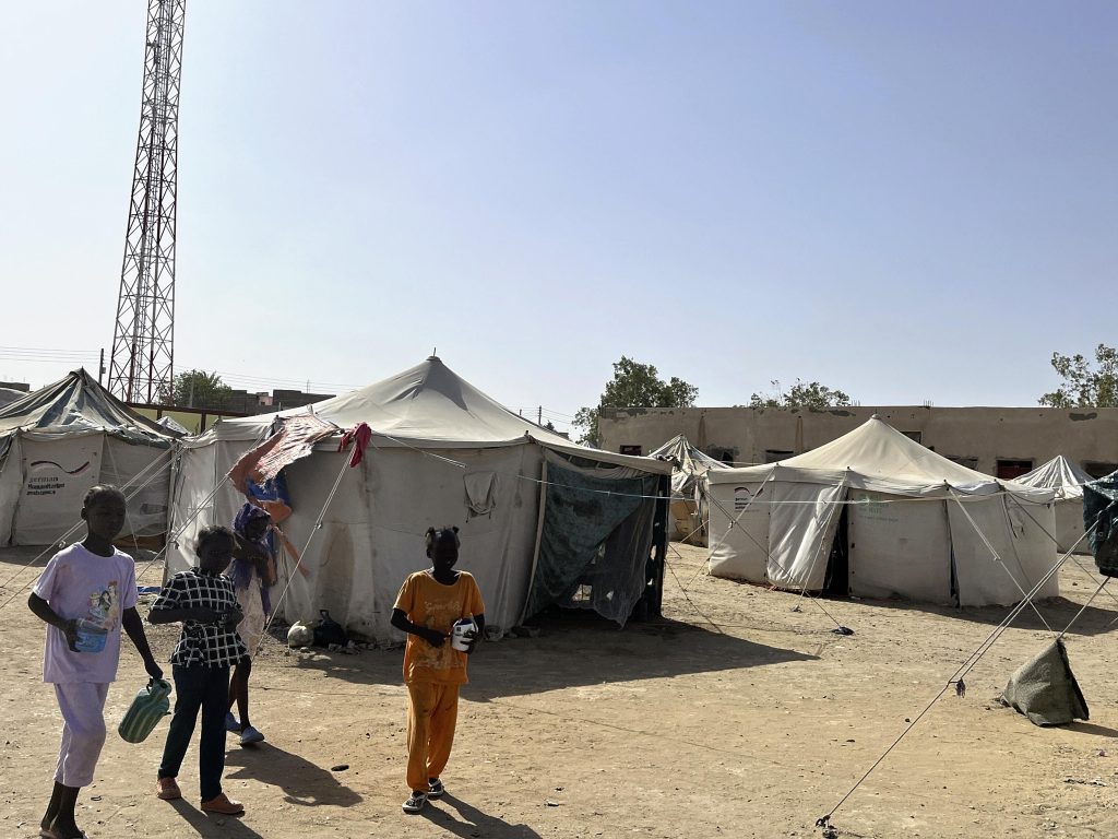 Children head to the washroom at a refugee camp in Port Sudan, eastern Sudan on May 3, 2025.