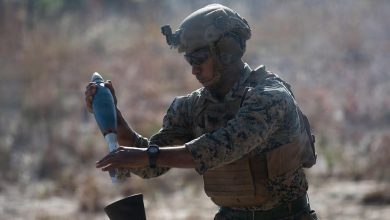 A US Marine loads a round in an 81mm mortar system.