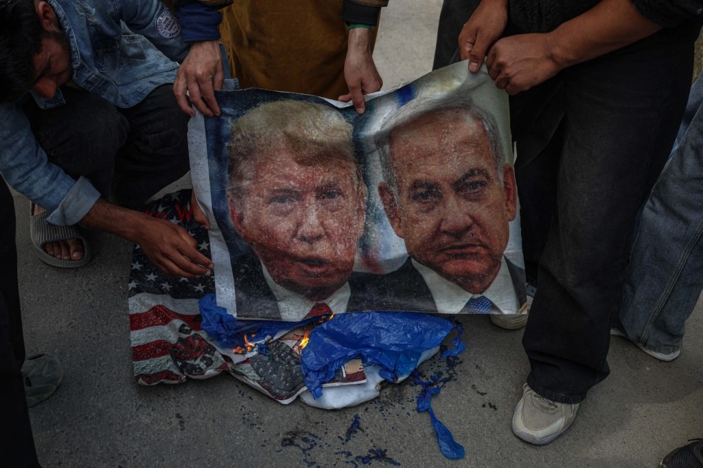 Shiite Muslims burn banners of US President Donald Trump and Israeli Prime Minister Benjamin Netanyahu during a protest against the killing of Iran's Supreme Leader Ayatollah Ali Khamenei in Budgam, northeast of Srinagar, Jammu and Kashmir, on March 6, 2026.