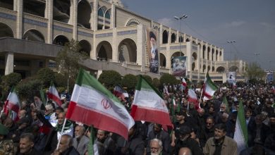 Iranian worshippers hold national flags and participate in Tehran's Friday prayers at Imam Khomeini Grand Mosque in Tehran, Iran, on March 6, 2026.