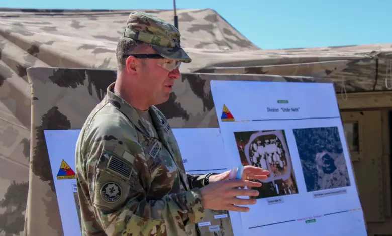 A US Army general briefs personnel during a Project Convergence CJADC2 demonstration at Fort Irwin.