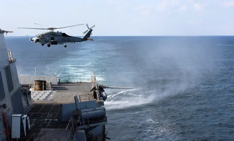 U.S. Navy destroyer USS Roosevelt transits the Strait of Hormuz, a strategic maritime chokepoint where low-cost asymmetric threats could disrupt global shipping and energy flows.