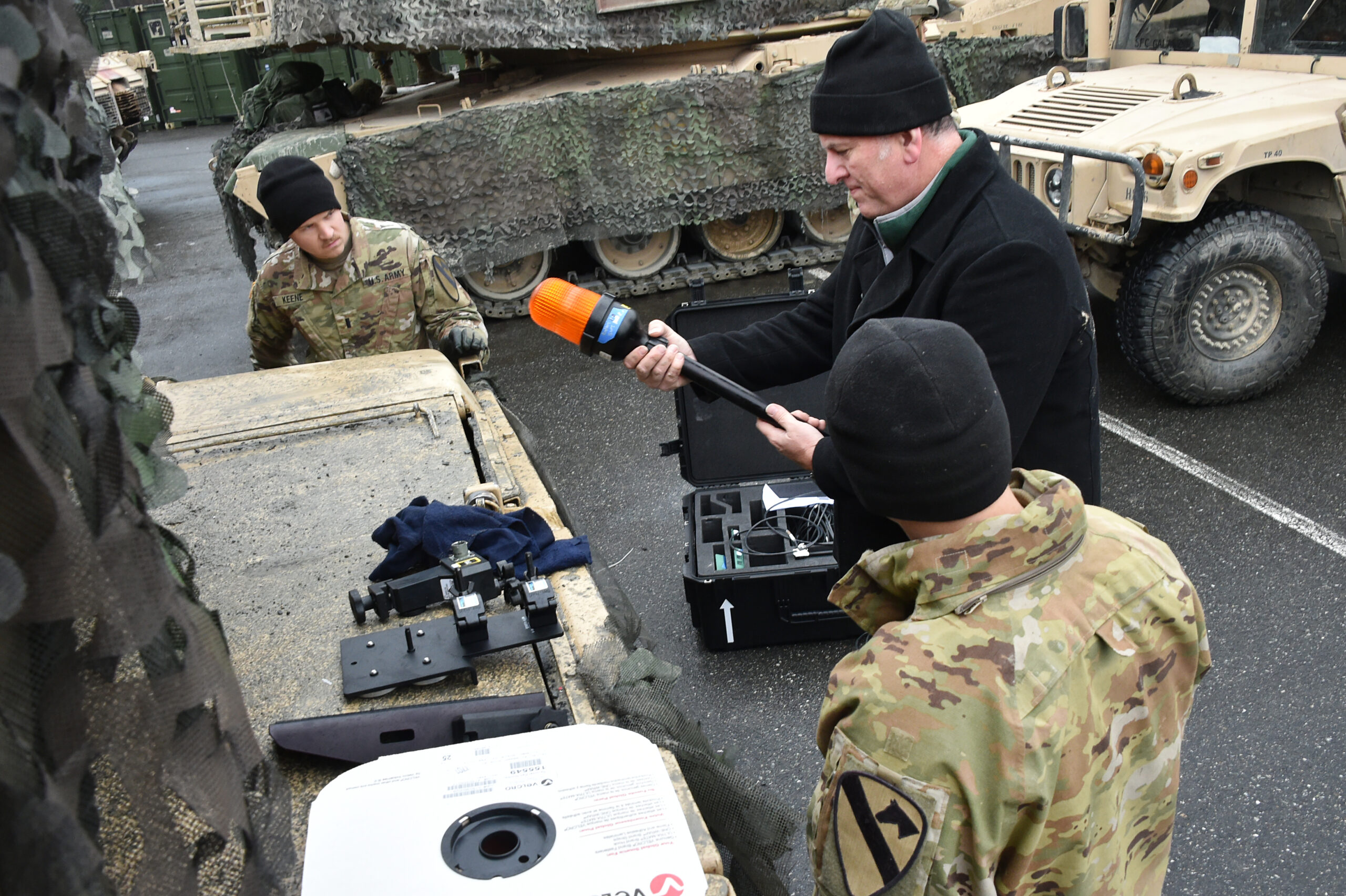 A contractor and a U.S. Soldier with 1st Battalion, 8th Cavalry Regiment, 2nd Armored Brigade Combat Team, 1st Cavalry Division set up a modernized vehicle tactical engagement simulation system (VTESS) on a M1A1 Abrams Main Battle Tank at the 7th Army Training Command’s Grafenwoehr Training Area, Germany, Jan. 9, 2020. The VTESS code modernization increases interoperability to conduct force-on-force training, addressing current training needs while supporting emerging army training requirements and systems. (U.S. Army photo by Gertrud Zach)