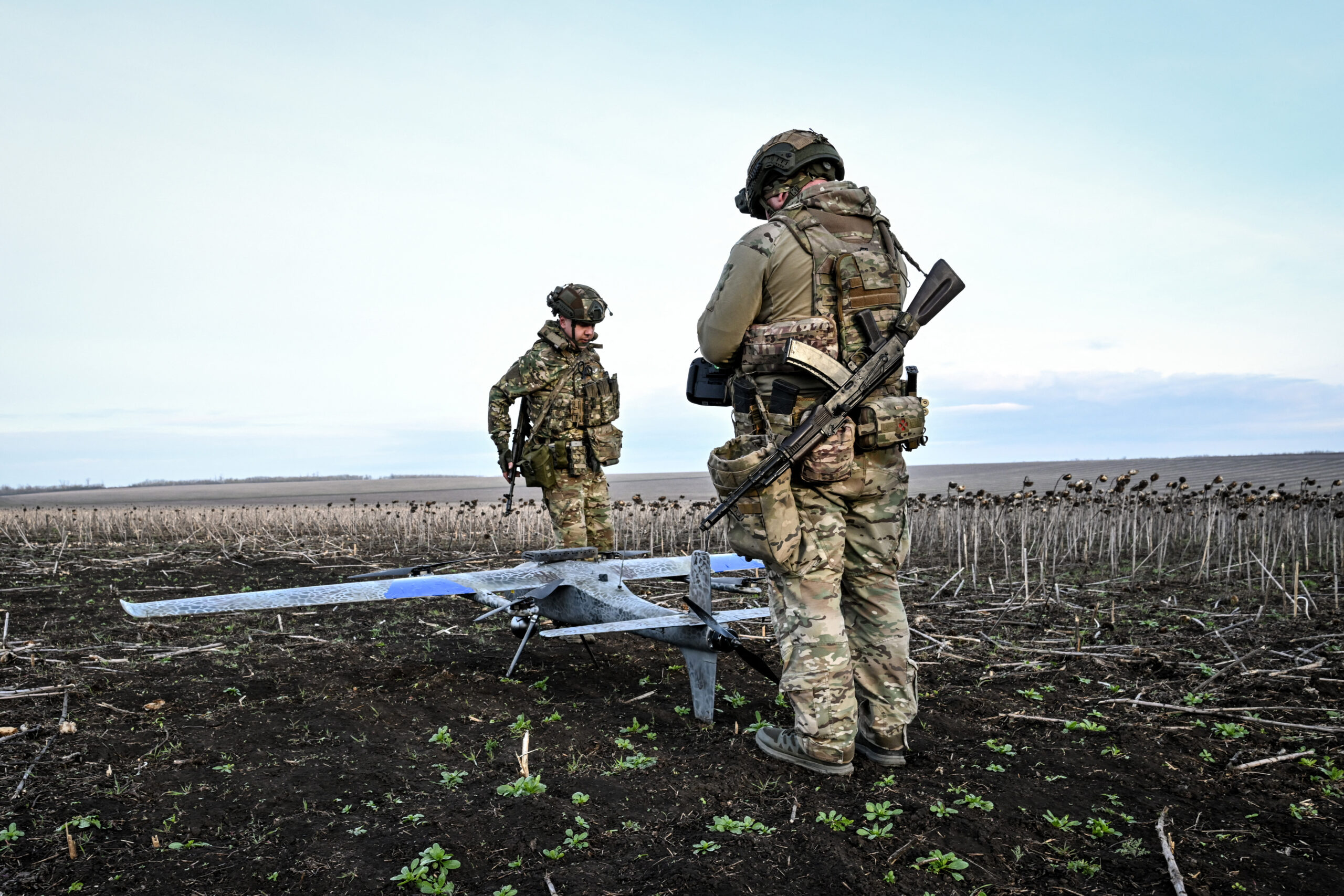 Soldiers carry a drone before launch in the Zaporizhzhia region.