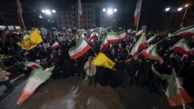 Pro-government supporters wave Iranian national flags and Lebanon's Hezbollah flags while participating in a nightly rally in a business district in downtown Tehran, Iran, on May 22, 2026.
