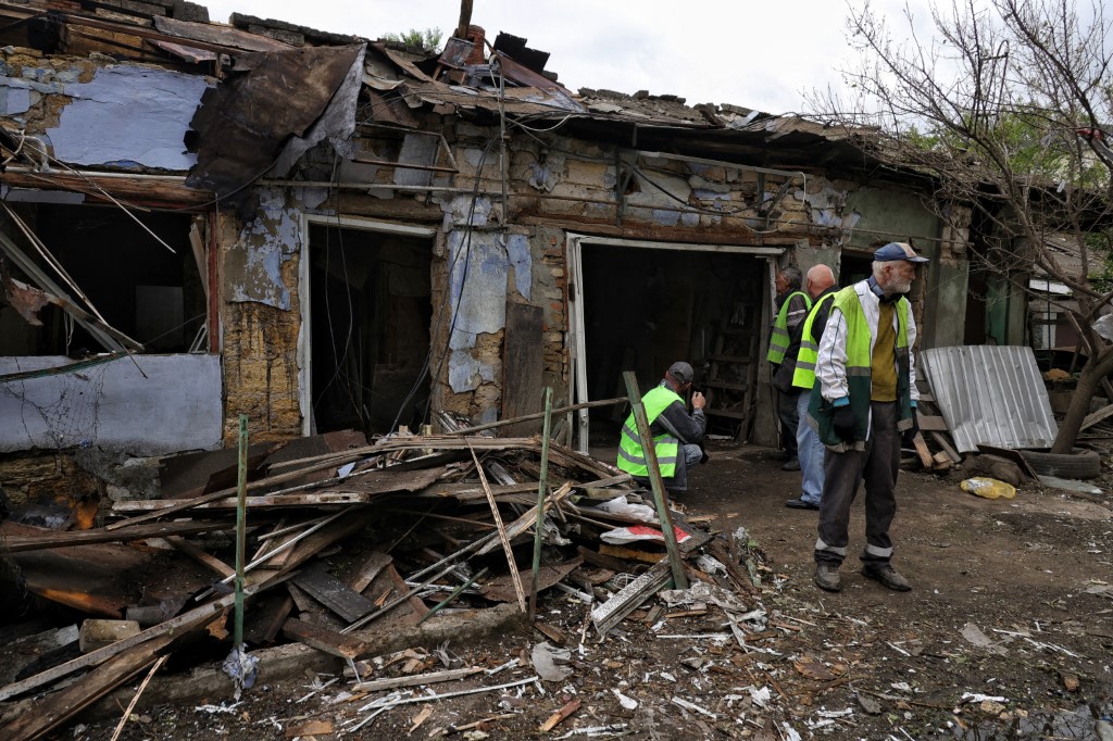 People in high-visibility vests clear debris after a Russian drone strike in Odesa, Ukraine, on June 1, 2026.