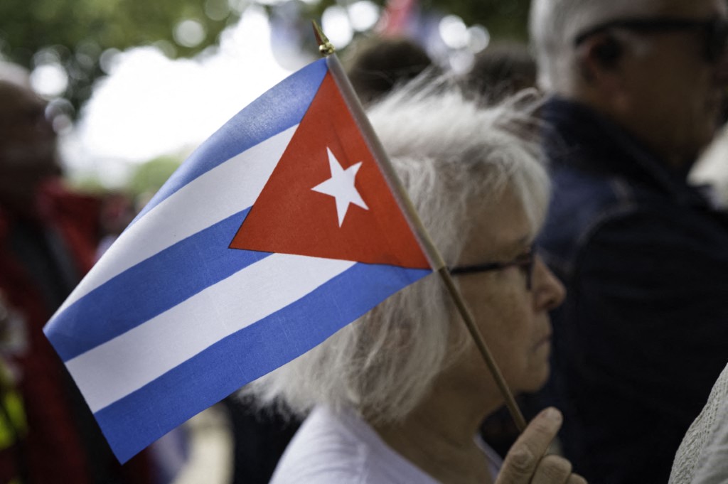 A woman holds a Cuban flag in Paris, France, on 11 June 2026.